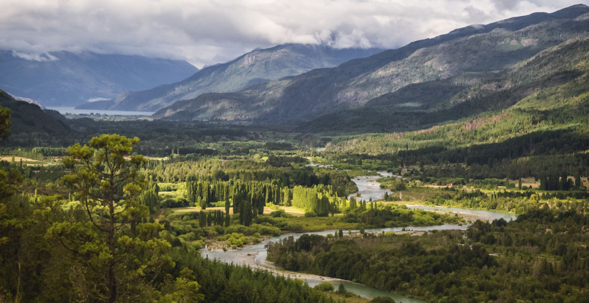 Landscape of Blue river, valley and forest in El Bolson, argentinian Patagonia.